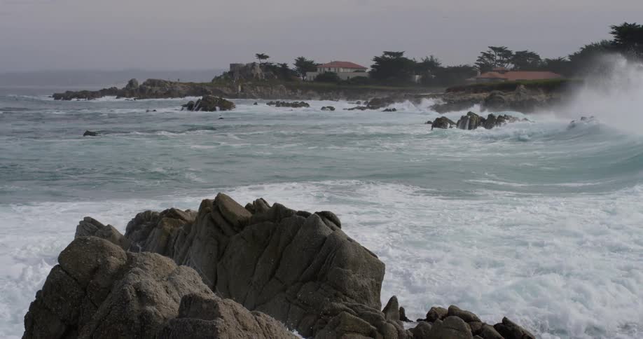 Waves crash against a rocky shoreline