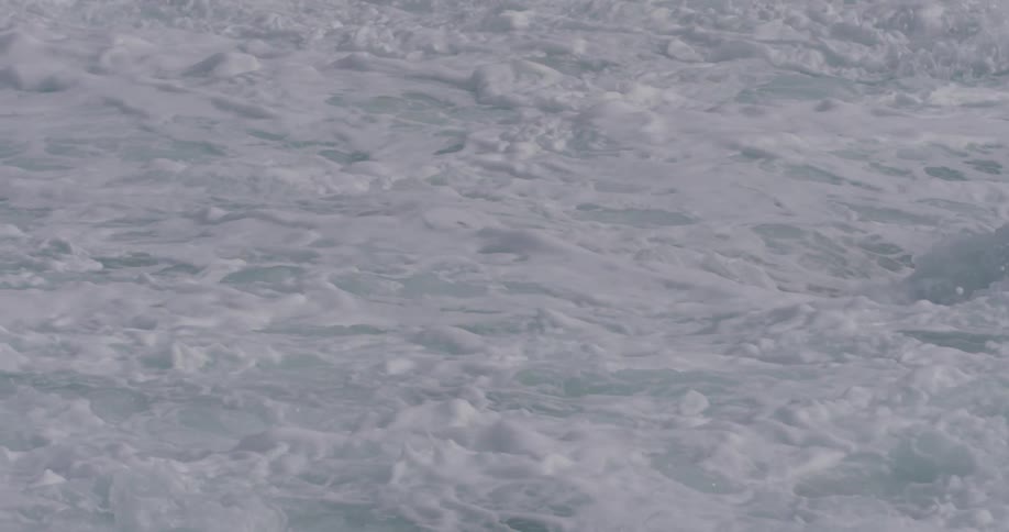 A wave crashes on the shore