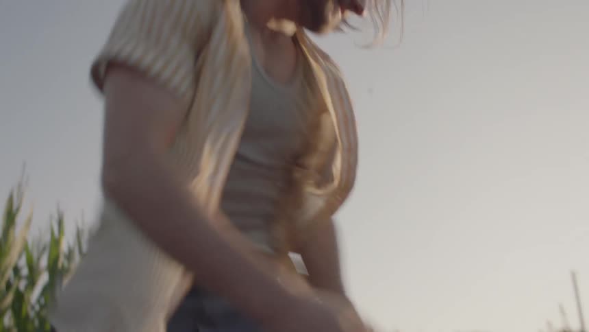 A man and a woman chasing down and getting in the back of a pickup truck
