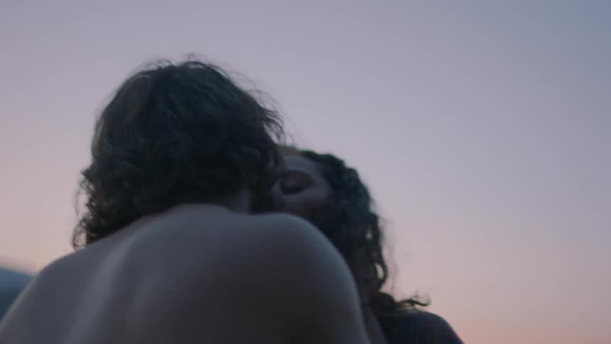 A man and a woman kiss
