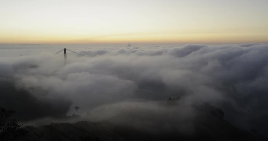Heavy clouds cover the bridge in the horizon