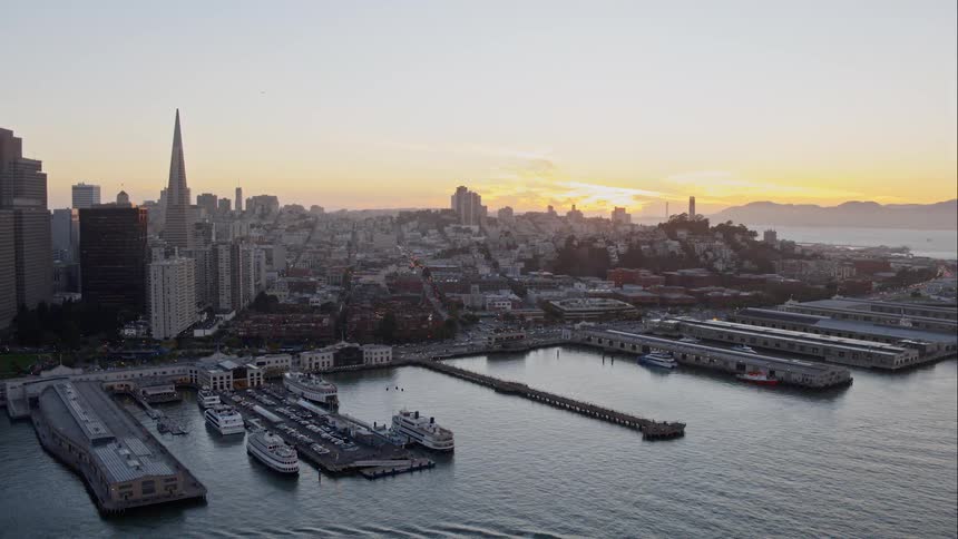 A harbor and a city skyline at sunset