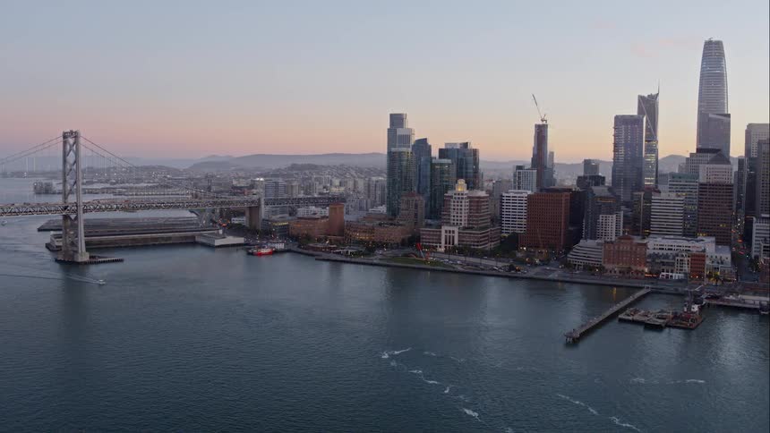 City skyline from waterfront with arch bridge