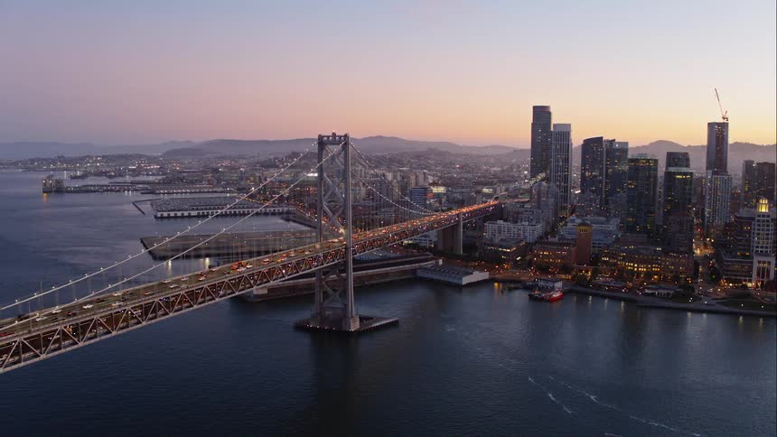 A bridge over water with the city in the background