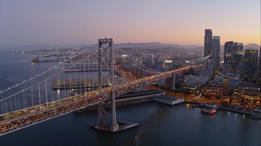 Skyline of the city where vehicles go over the bridge at dusk