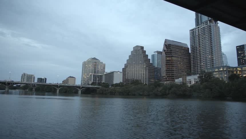 A view of the city from under a bridge on a cloudy day