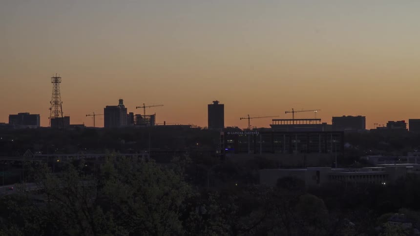 Timelapse of a panning view of city traffic at dawn