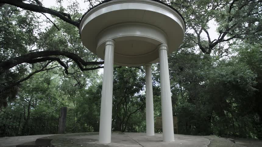 White gazebo surrounded by trees