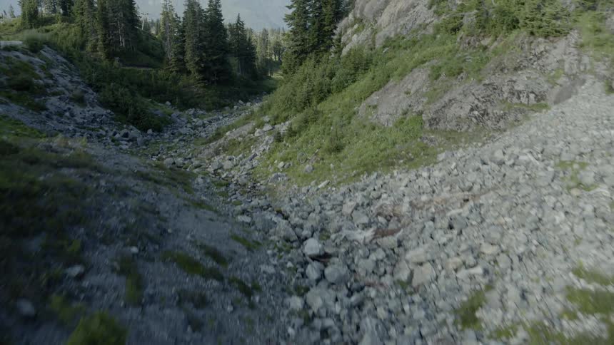 Descending down along a winding mountain valley stream