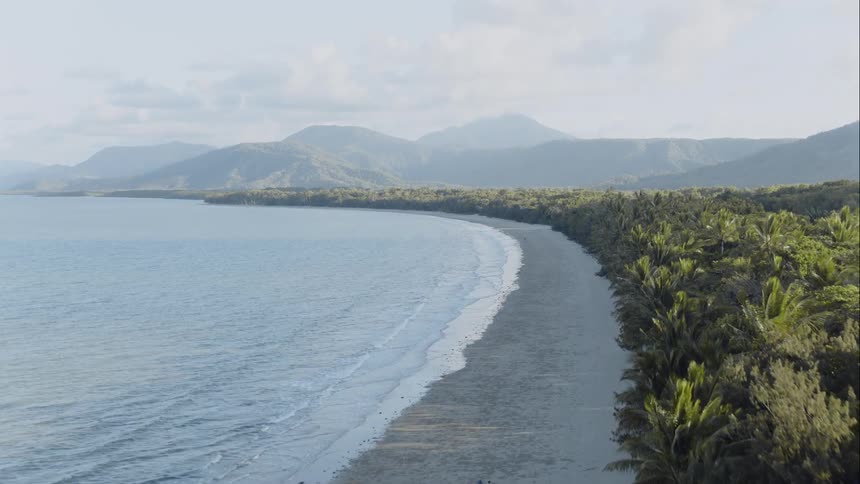 View of coastline while the waves hit the beach slowly