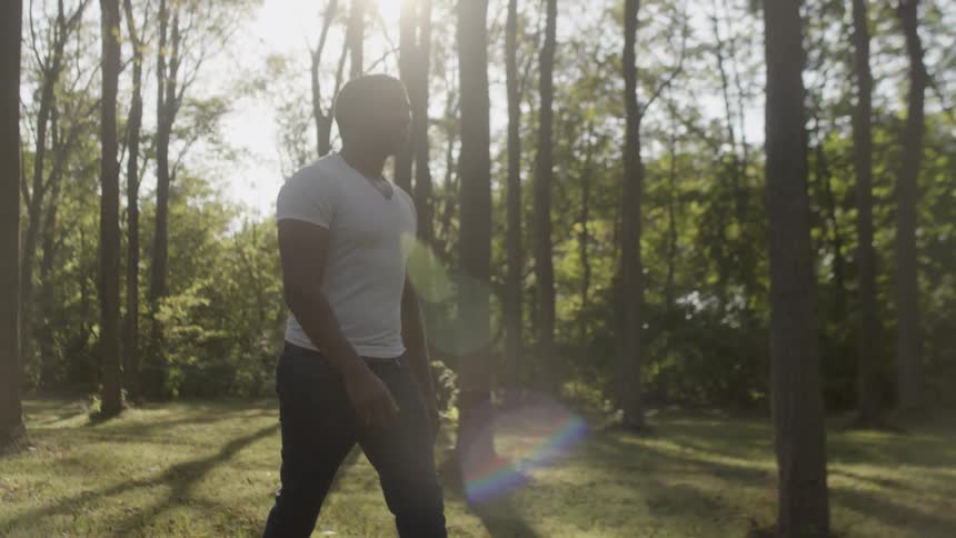 Man walking on a trail in the forest in the afternoon