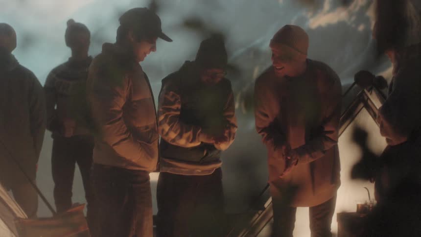 People standing over a fire warming up