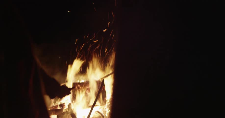 People are dancing around a fire