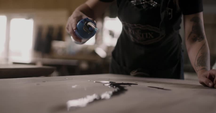 A woman uses a torch