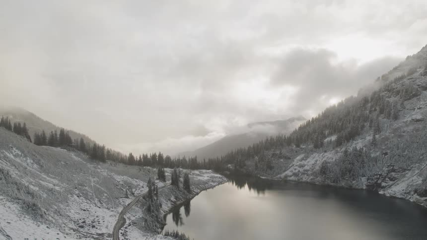 An aerial view of a mountain lake in winter