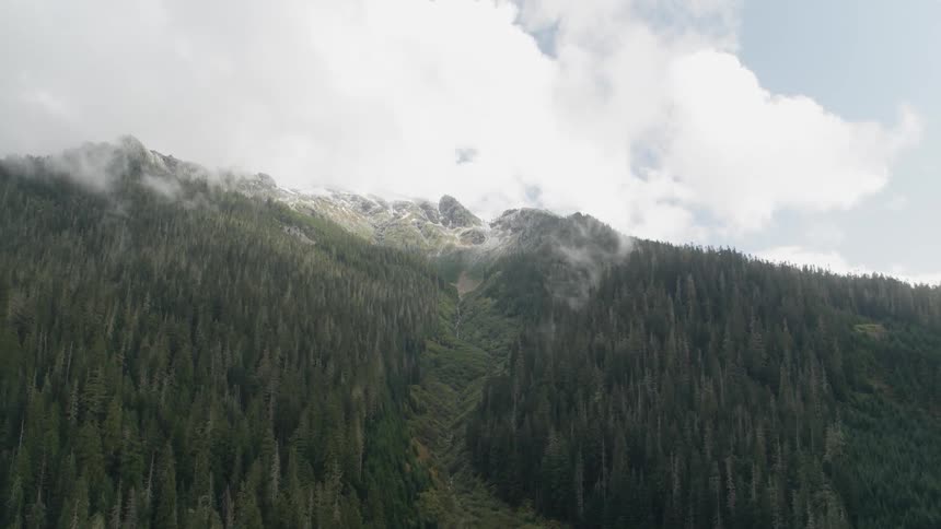 Clouds hover over a mountain top