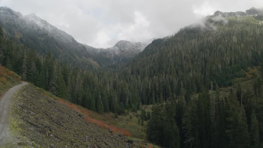 Clouds hang over a mountain pass