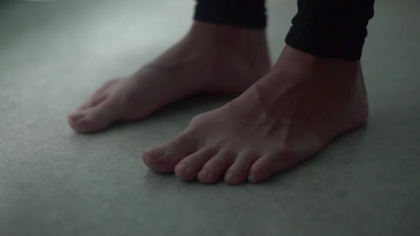 A woman with bare feet standing on the ground
