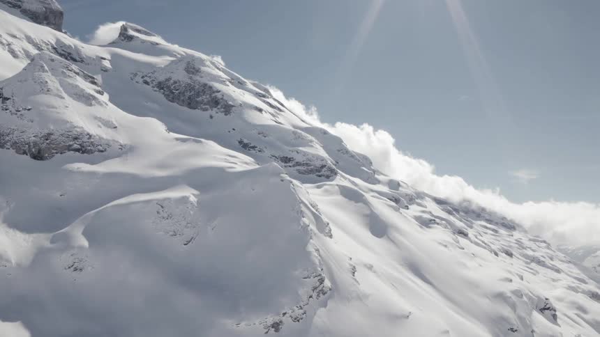 Aerial view of a snow covered mountain slope on a clear day