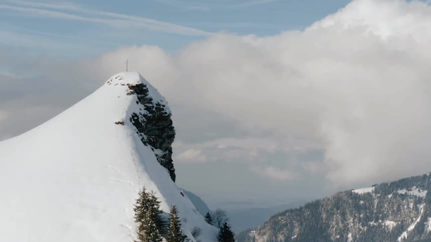 Snow and clouds are covering the mountain tops