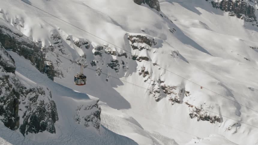 A gondola lift carrying people up the mountain