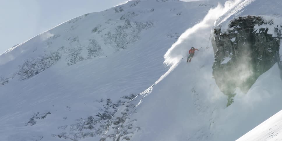 A person skis down a mountain