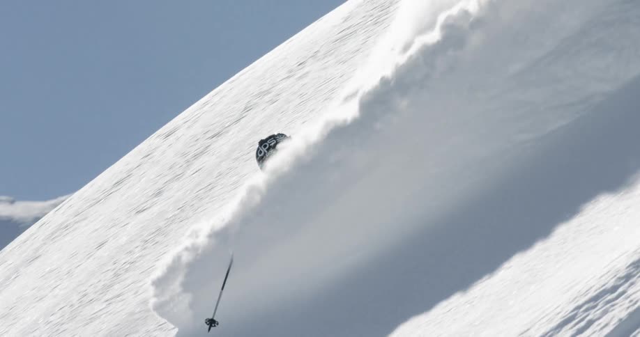 A man skiing down a steep mountain