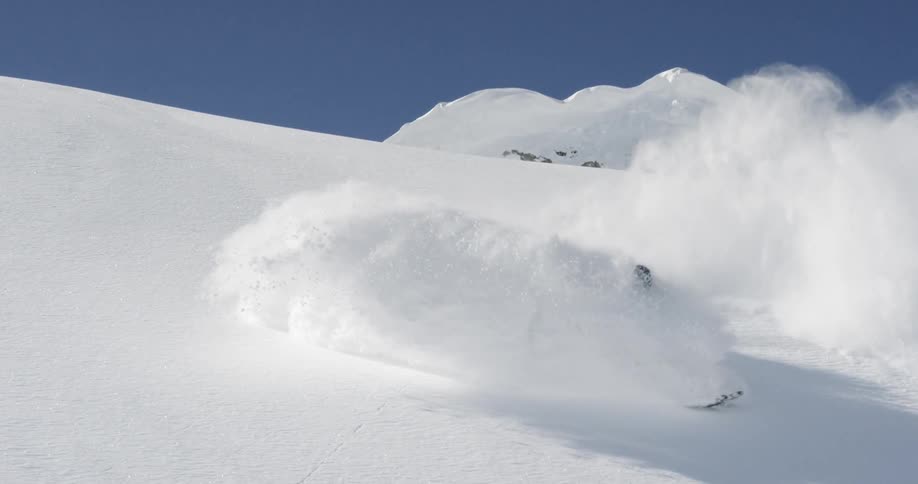 A person skiing down a mountain that is covered in snow