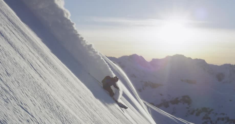 A person is skiing down the side of a mountain
