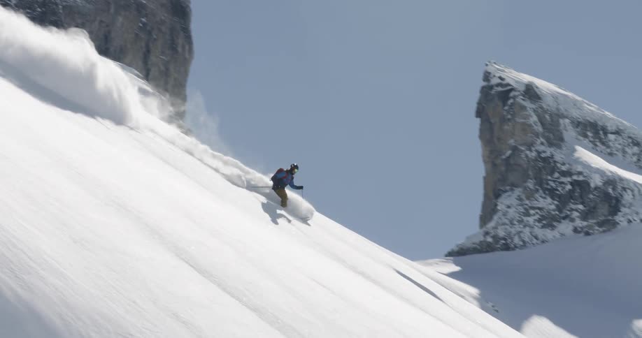Someone skis down the mountain