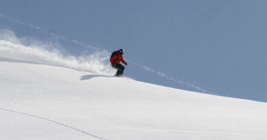 A skier skiing on a large pile of snow