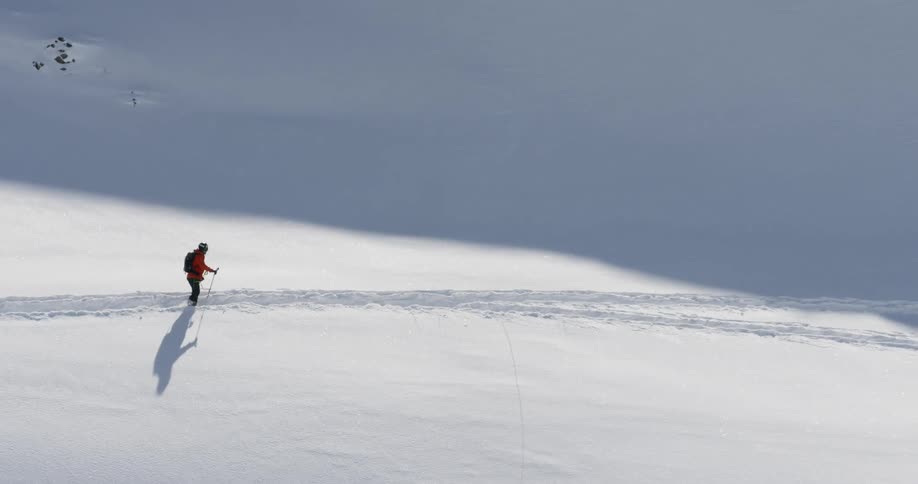 A man is skiing in the snow outdoors