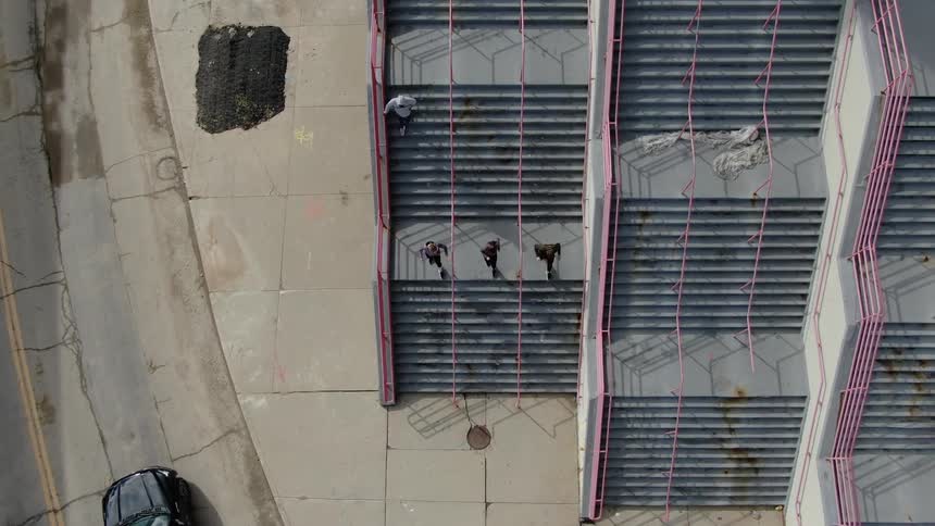 A group of joggers quickly descending a concrete staircase