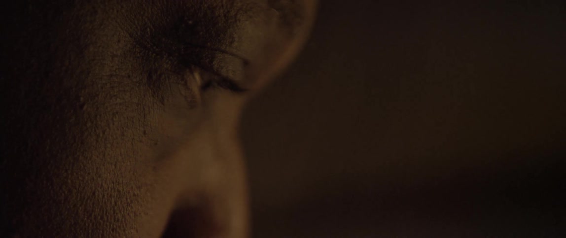 A black man stares with extreme focus