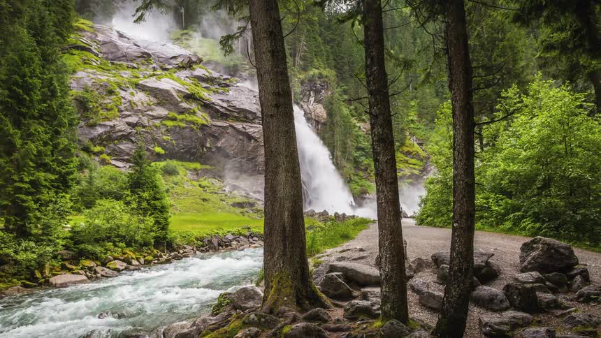 A rushing waterfall and river in a park in the summer