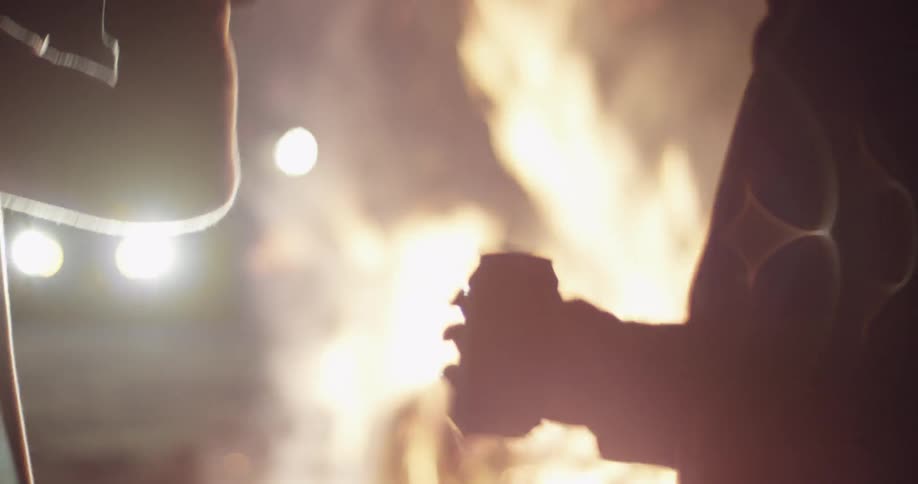 People are dancing around a fire