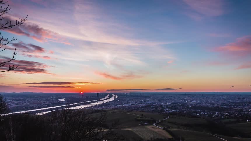 The sun rises on a dark night city landscape