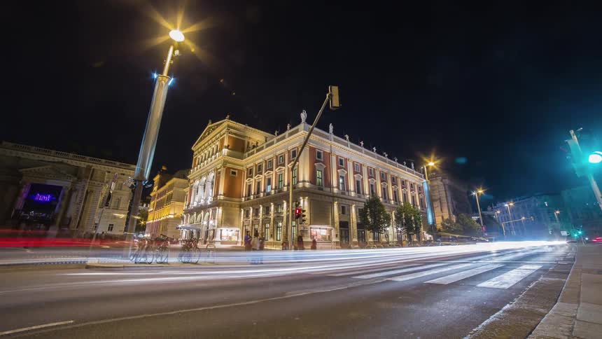 Traffic moves through intersection at night