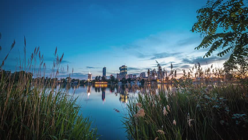 A lake sits in front of a large city