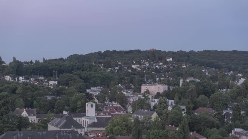 A tree filled village during sunrise