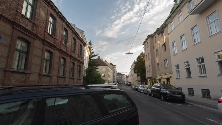 Cars drive down a city street