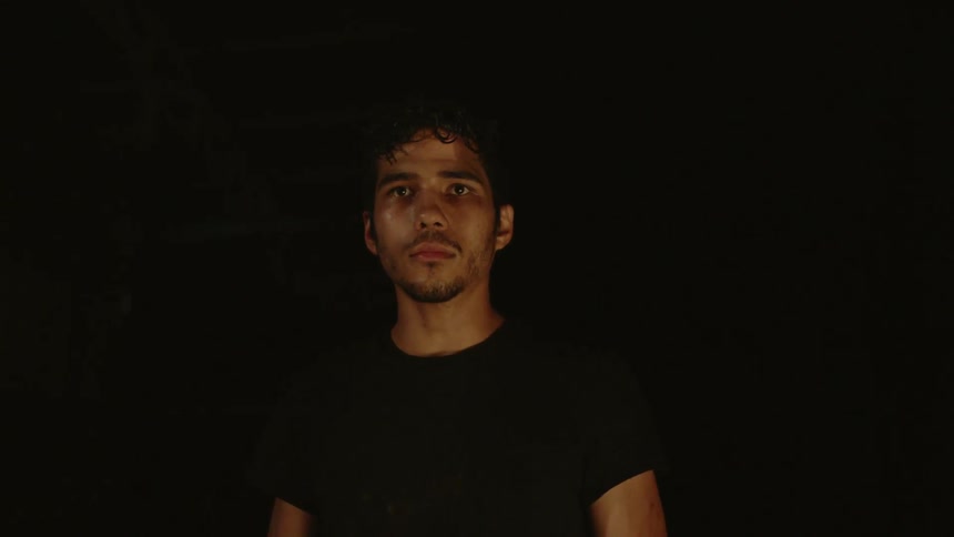 Lightning flashing behind a man who appears nervous