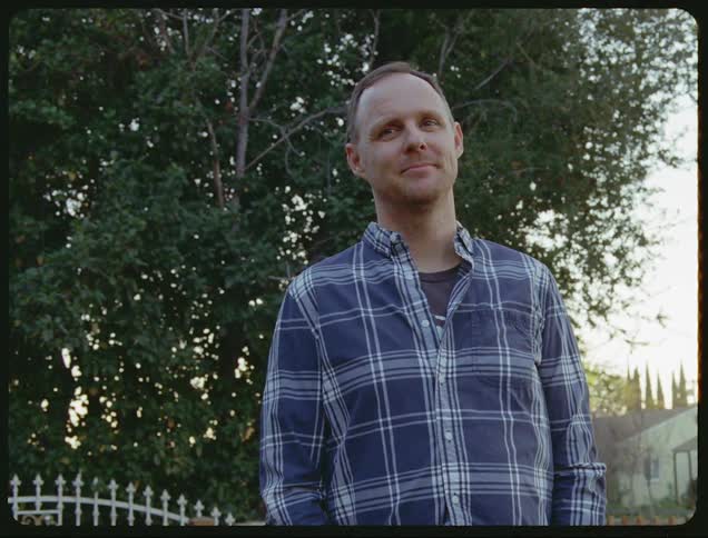 A man standing around outdoors looking into the distance