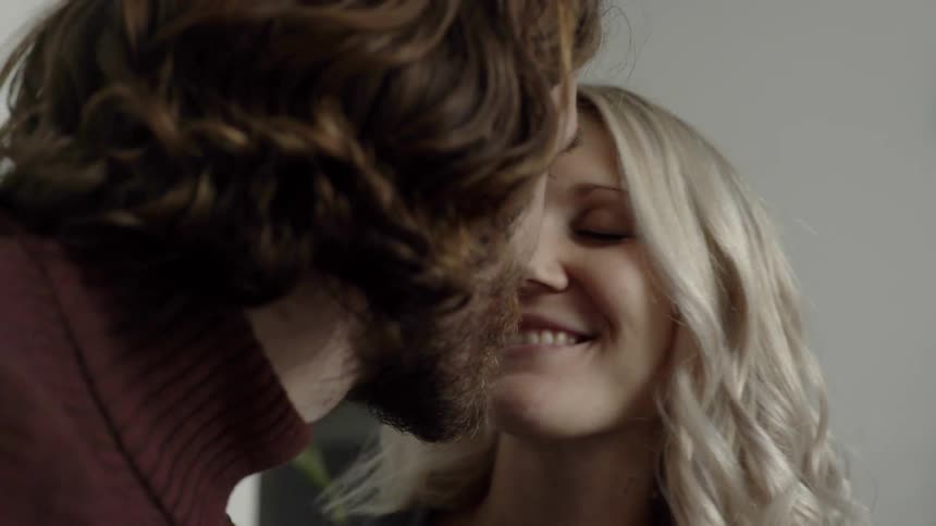 Female and male couple smiling and kissing each other