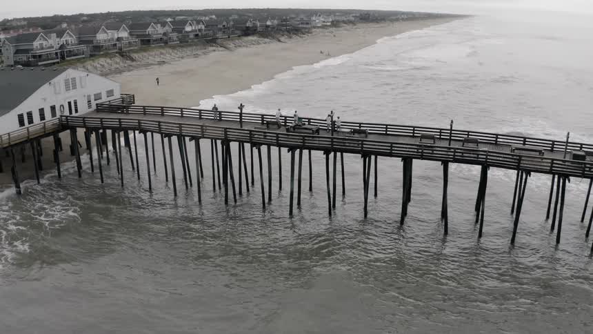 Landscape view of a dock with people standing on it