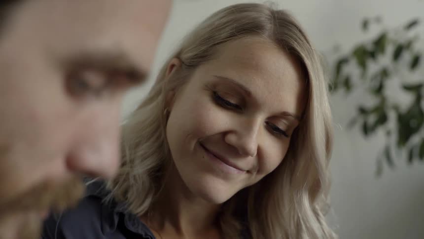 A woman smiles lovingly to a man