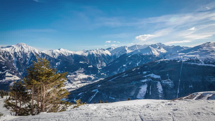 Clouds move over a snow covered mountain range