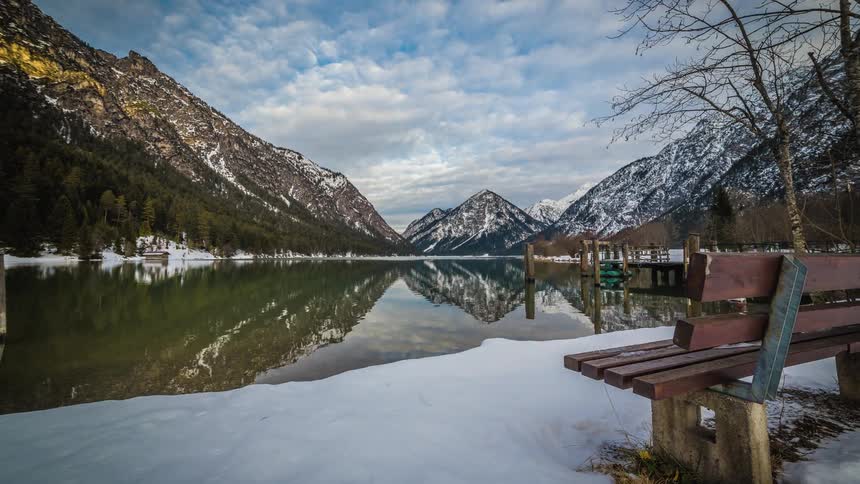 A bench faces the mountains