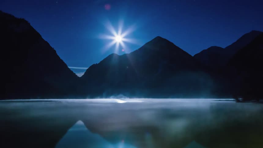 Mist moves across a lakes surface