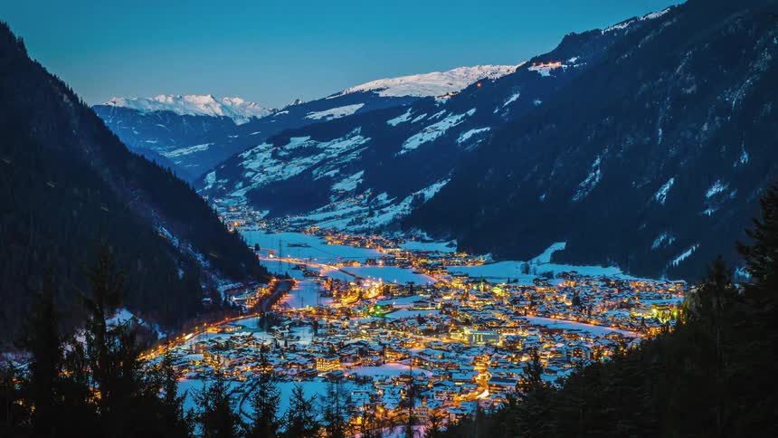 Time lapse of a ski valley resort town through the sunset and into the night